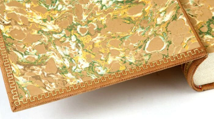 The leather-bound book "A study on the nature and causes of the wealth of nations" by A.Smith