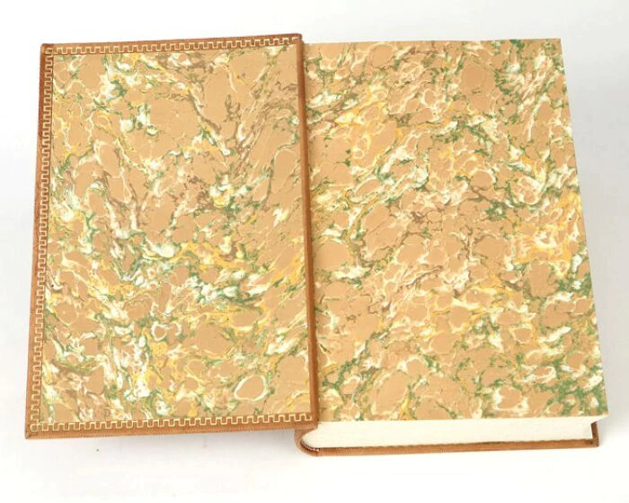 The leather-bound book "A study on the nature and causes of the wealth of nations" by A.Smith