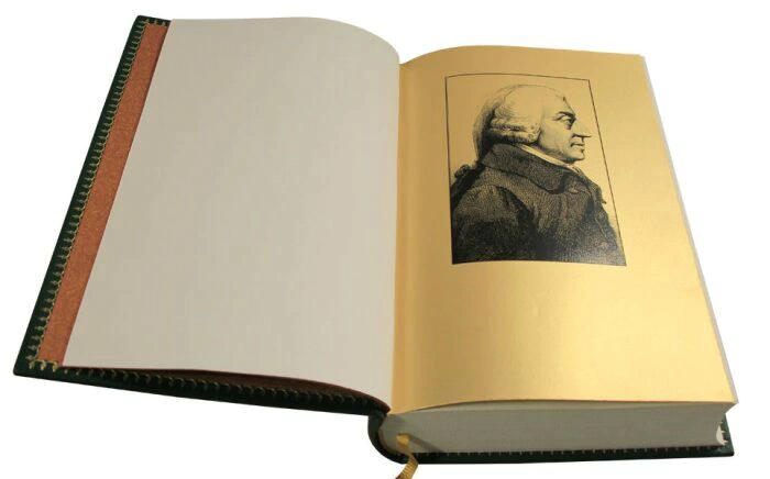 The leather-bound book "A Study on the nature and causes of the Wealth of Nations" by Adam Smith