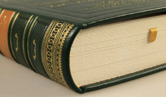 The leather-bound book "A Study on the nature and causes of the Wealth of Nations" by Adam Smith