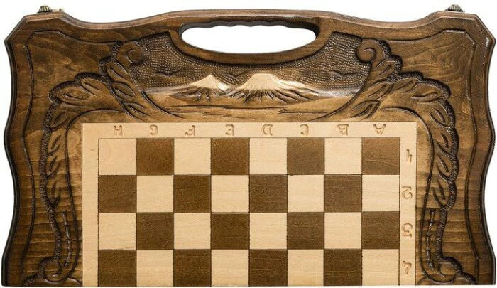 A small carved "Mountain Peaks" game set (chess, backgammon and checkers) with a handle
