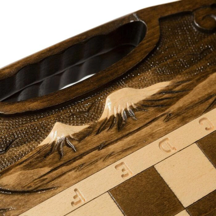 A small carved "Mountain Peaks" game set (chess, backgammon and checkers) with a handle