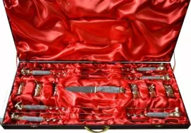 A set for a barbecue made of marble with cups and with a Damascus steel knife