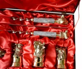 A set for a barbecue made of marble with cups and with a Damascus steel knife