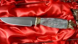 A set for a barbecue made of marble with cups and with a Damascus steel knife