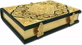 Koran with filigree (gold), casting and garnets in a suede casket