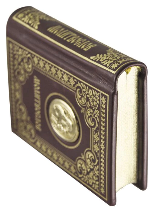 A leather-bound book "Prayer Book" with an image