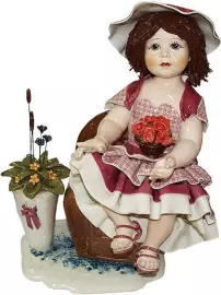 Statuette "Doll with flowers sitting on an armchair"