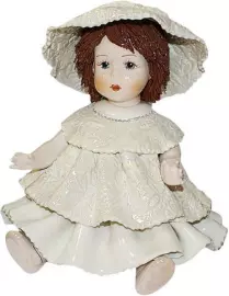 Statuette "A doll sitting with dark hair in a white dress"