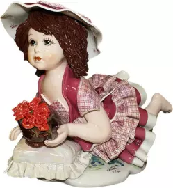 Statuette "Doll with flowers lying on a pillow"