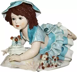 Statuette "Doll with a bear lying on a pillow"
