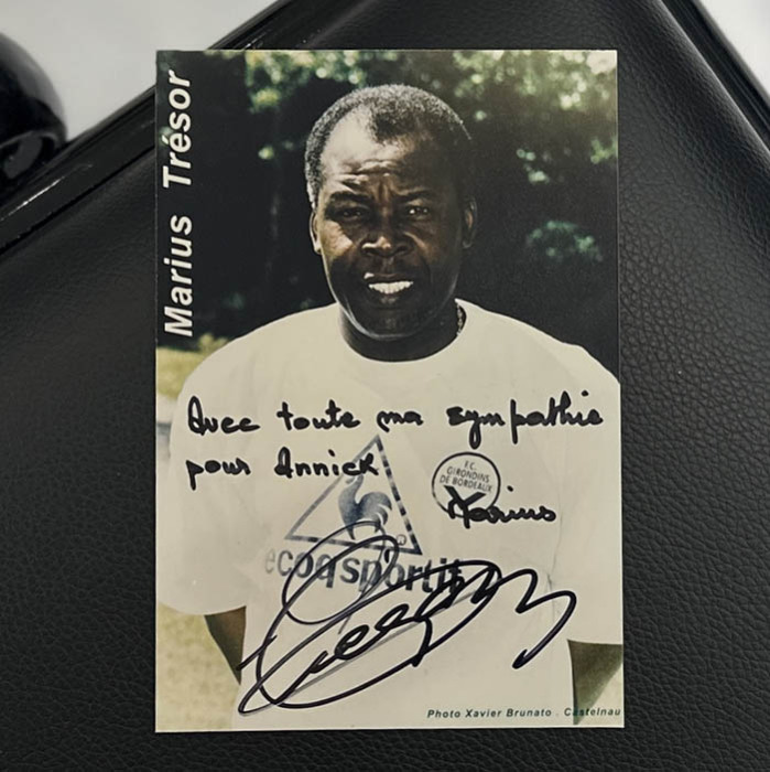 A photo with a handwritten address and an autograph. Marius Trezor