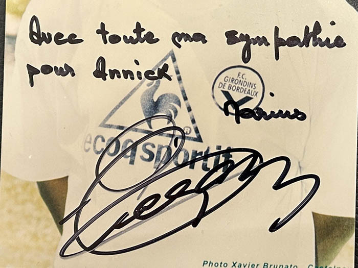 A photo with a handwritten address and an autograph. Marius Trezor