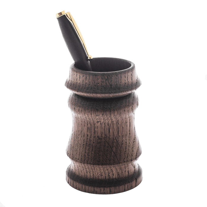 A pen and pencil holder made of stained oak