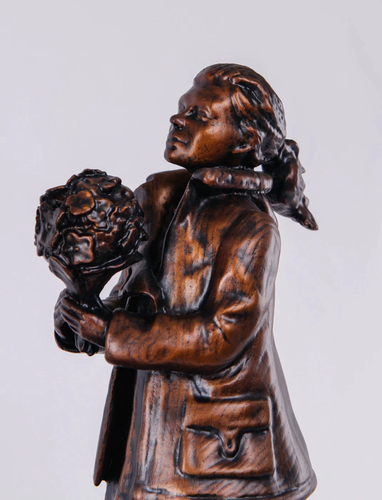 Statuette of beech "Polite people" on the bedside table