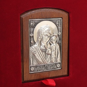 A leather-bound book "Prayer Book of an Orthodox Cossack" with an icon of the "Kazan Mother of God"