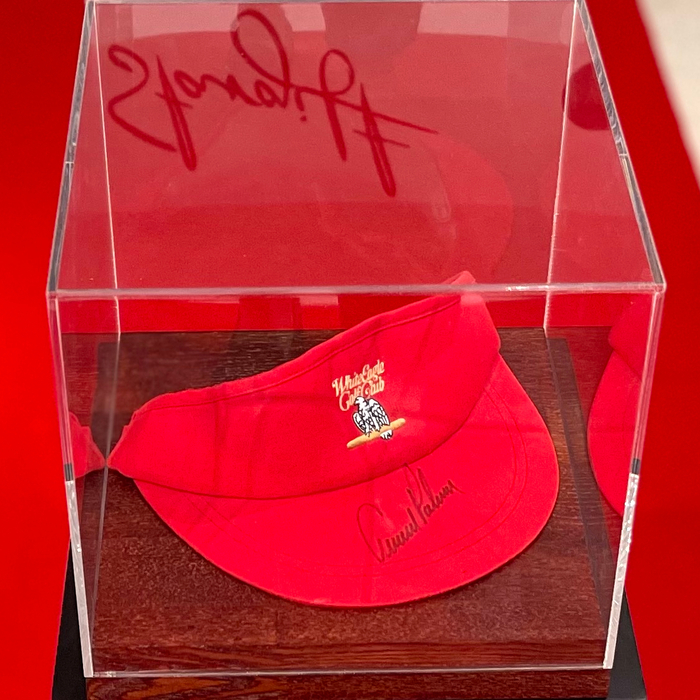 An autographed visor cap by golfer Arnold Palmer