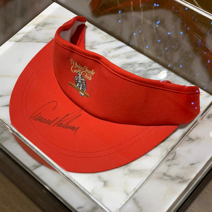 Cap-visor autographed by golfer Arnold Palmer, white marble
