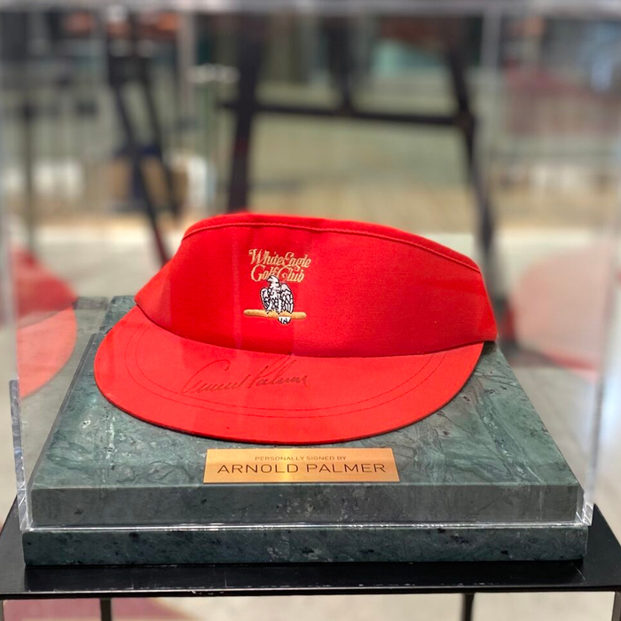 Cap-visor autographed by golfer Arnold Palmer, green marble