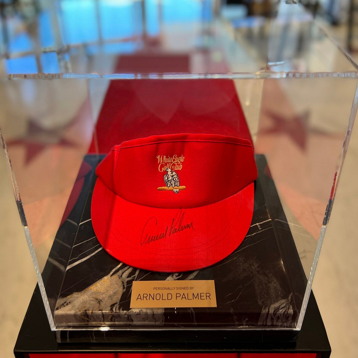 Cap-visor autographed by golfer Arnold Palmer, black marble