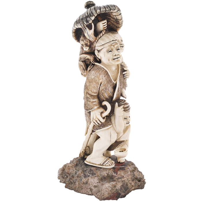 A souvenir from a mammoth tusk "A family with a monkey under an umbrella"