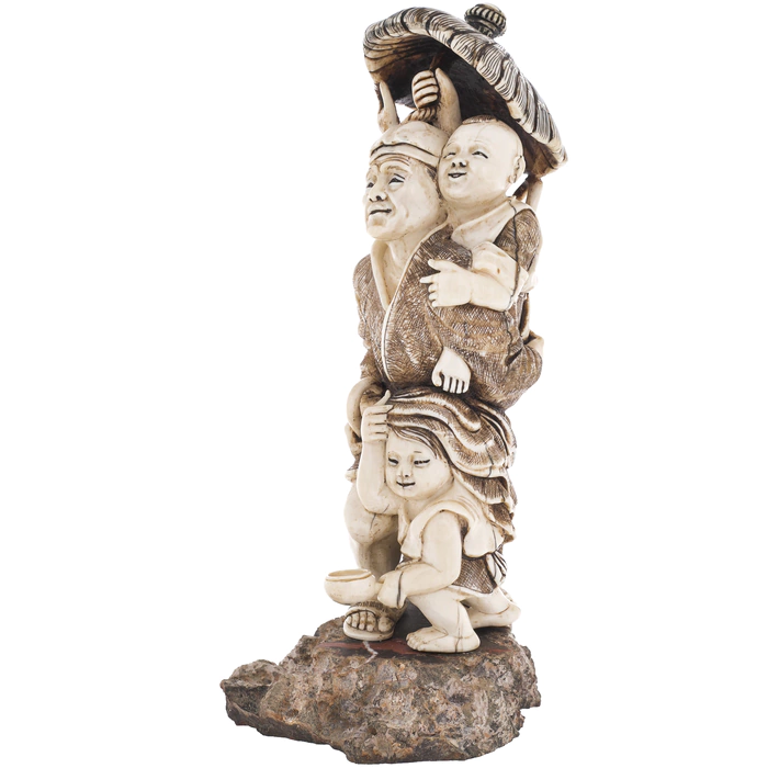 A souvenir from a mammoth tusk "A family with a monkey under an umbrella"