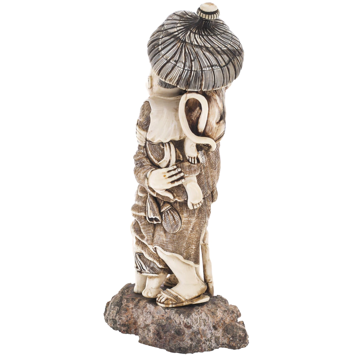 A souvenir from a mammoth tusk "A family with a monkey under an umbrella"