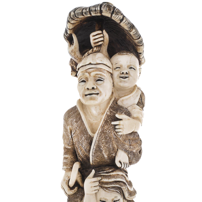 A souvenir from a mammoth tusk "A family with a monkey under an umbrella"
