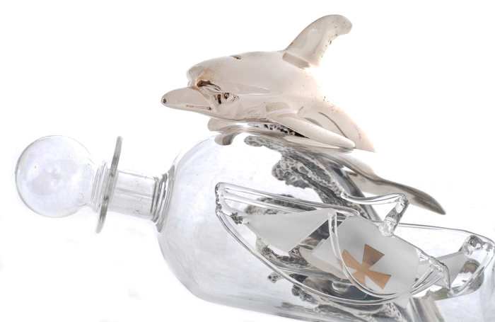 Statuette "Dolphin with a bottle" with silver coating
