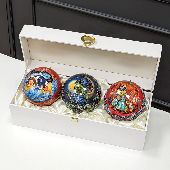 A set of wooden Christmas tree balls "Palekh fairy tales" in a gift box