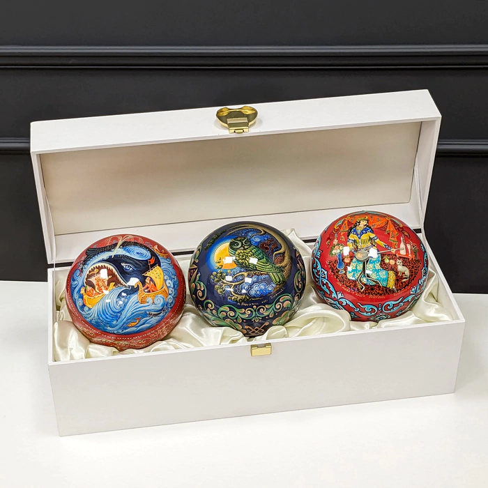 A set of wooden Christmas tree balls "Palekh fairy tales" in a gift box