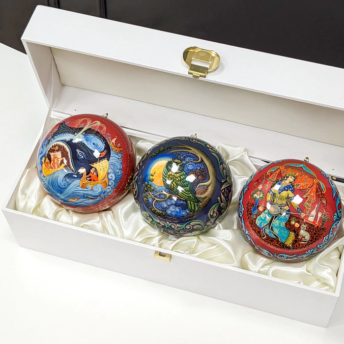 A set of wooden Christmas tree balls "Palekh fairy tales" in a gift box