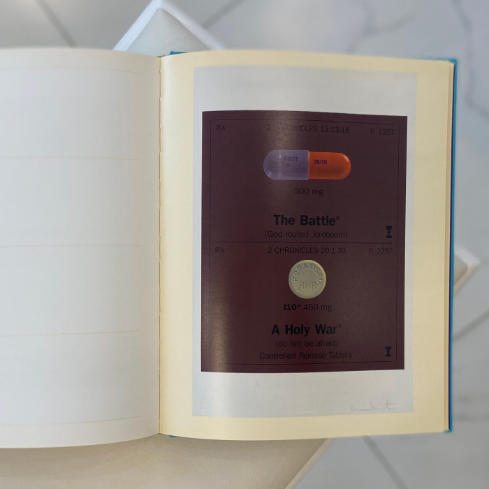 A book with a handwritten wish, drawing and autograph by artist Damien Hirst