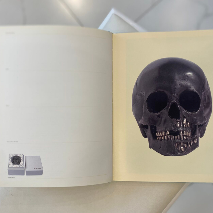 A book with a handwritten wish, drawing and autograph by artist Damien Hirst