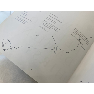 A book with a handwritten wish, drawing and autograph by artist Damien Hirst