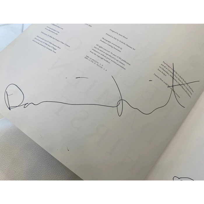 A book with a handwritten wish, drawing and autograph by artist Damien Hirst