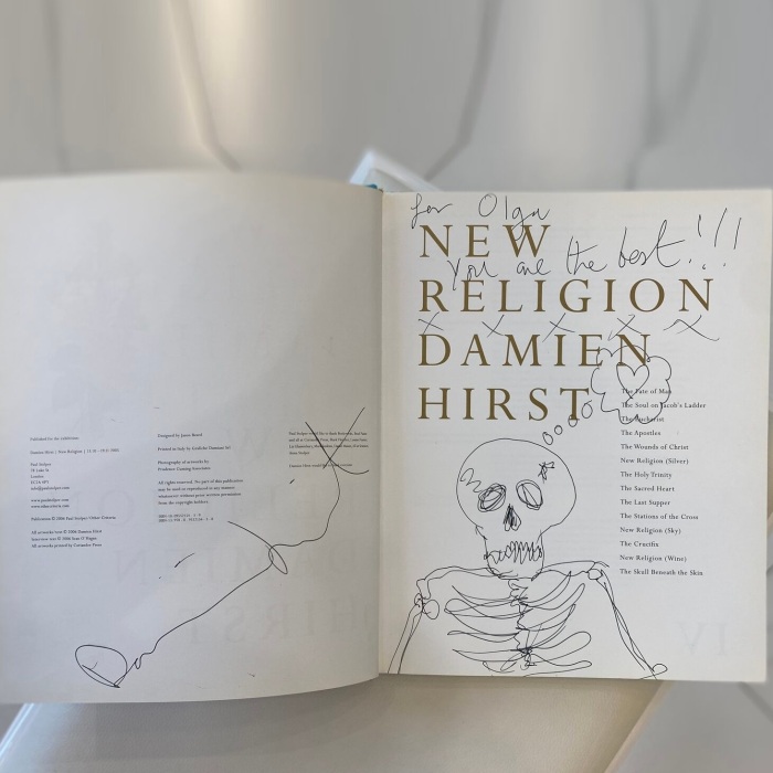 A book with a handwritten wish, drawing and autograph by artist Damien Hirst
