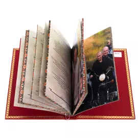 The leather-bound book "Putin. Quotes and aphorisms" on a rotating platform