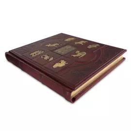 The leather-bound book "The Big Book of Russian Hunting" by L.P. Sabaneev.