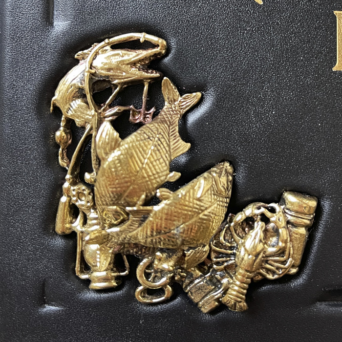 The leather-bound book "The Big Book of Russian fishing" by L.P. Sabaneev.