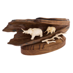 Sculpture of mammoth tusk and oak "Two mammoths in a cave on a stand"