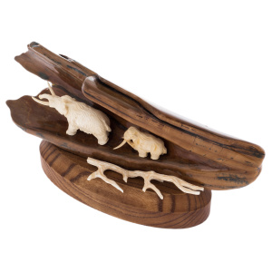 Sculpture of mammoth tusk and oak "Two mammoths in a cave on a stand"