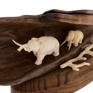 Sculpture of mammoth tusk and oak "Two mammoths in a cave on a stand"