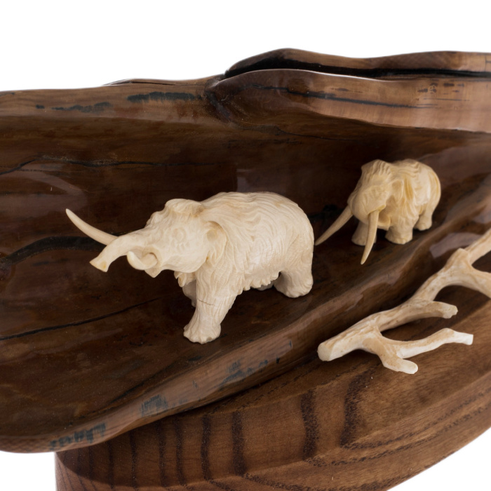 Sculpture of mammoth tusk and oak "Two mammoths in a cave on a stand"