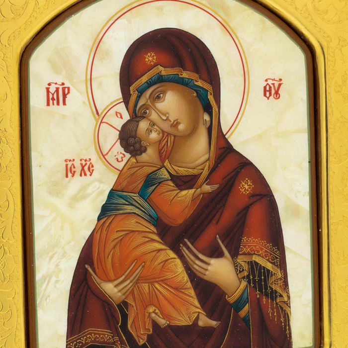 Mother-of-pearl icon of the Vladimir Mother of God in a gold frame with embossing