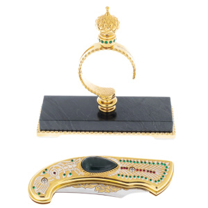 Folding knife on a stand made of green jasper