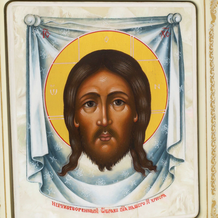 Icon on natural mother-of-pearl "Saved by Man-made" in a white frame