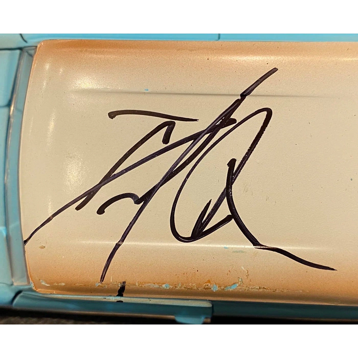 A model of a car from the movie "Harry Potter and the Chamber of Secrets" with an autograph by Daniel Radcliffe.