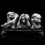 Silver sculpture "Three monkeys" on obsidian