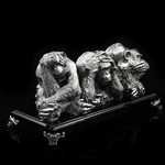 Silver sculpture "Three monkeys" on obsidian